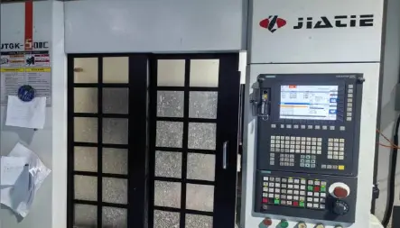 CNC machining center control and enclosure in the MIGE workshop
