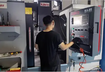 Operator working with CNC equipment in the MIGE workshop