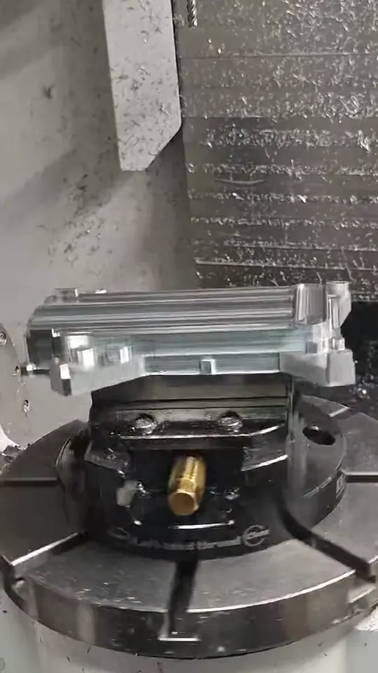 Finished aluminum component displayed on the machining fixture